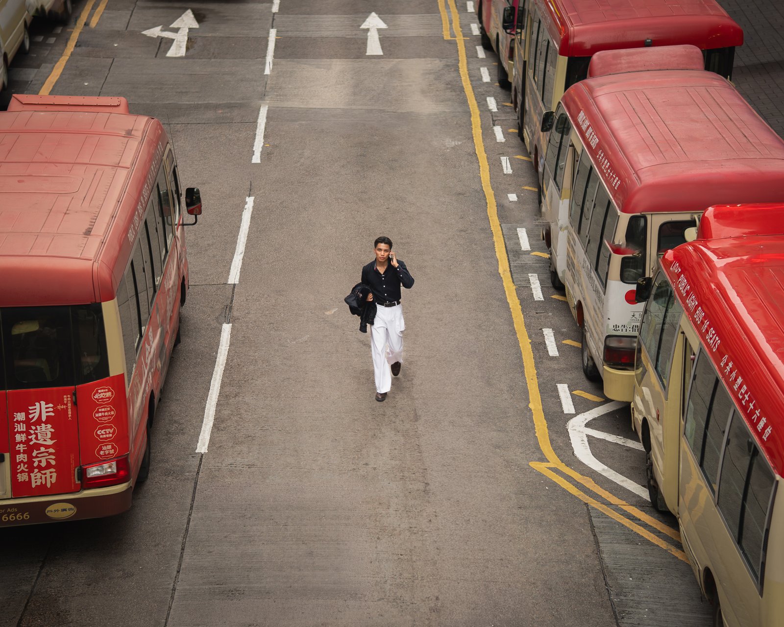 Lou Villaluna standing on a city street in an embroidered jacket